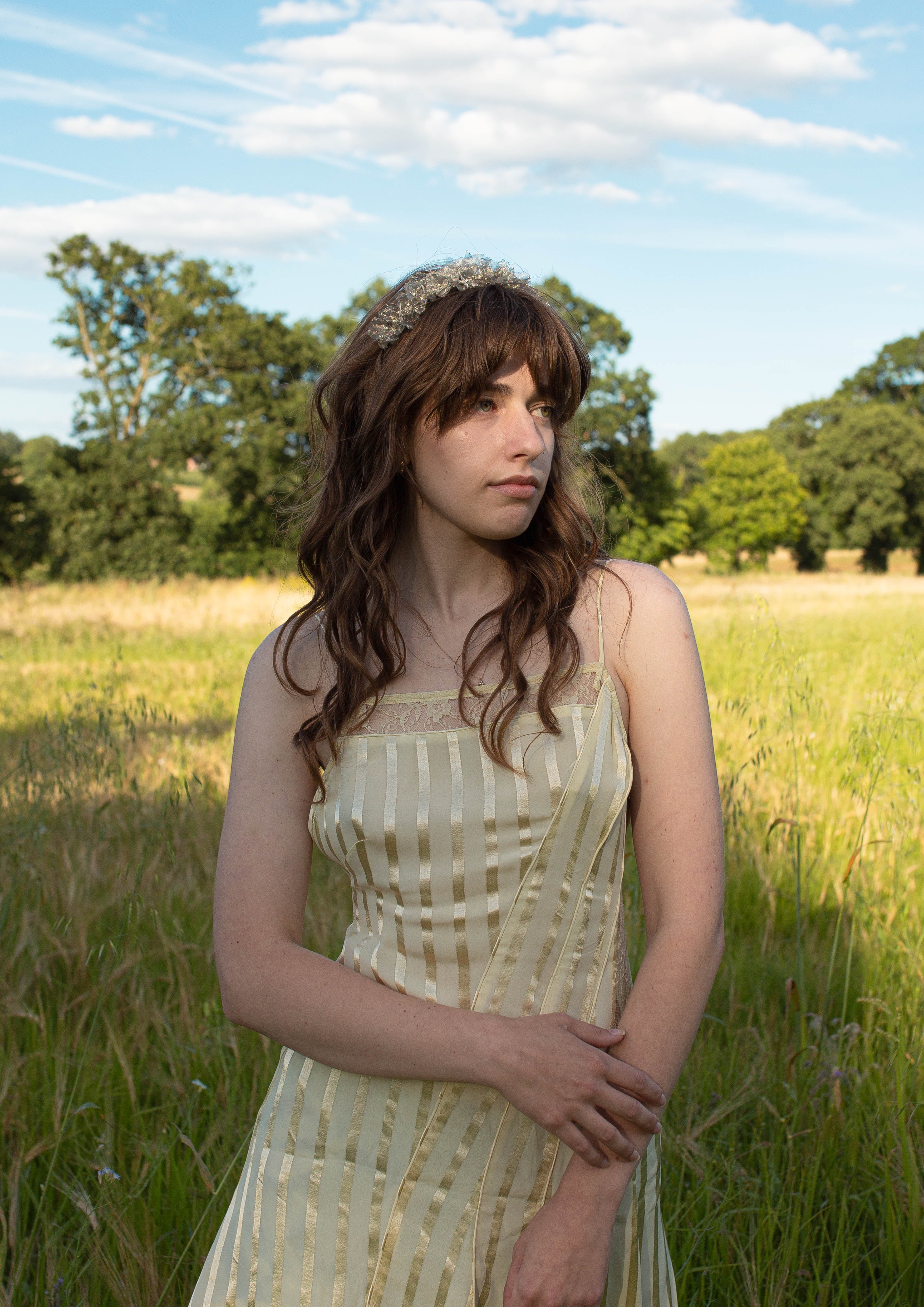 hydrangea blossom pearl silver headband, worn by model in a beautiful sun soaked field 